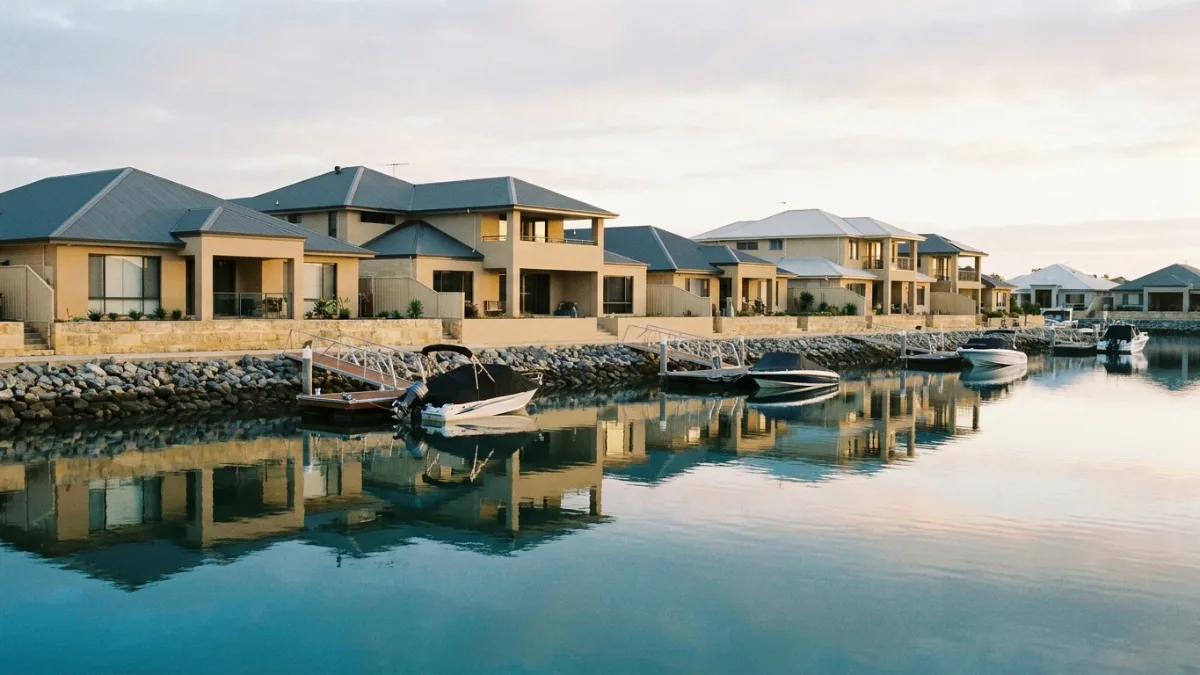Canal-front homes with private pontoons on still water, typical of Southport on the Gold Coast